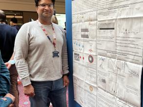 A photograph of Manish Singh Kushwah with his poster.